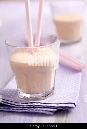 Papaya lassis in glasses with cinnamon, yoghurt and straws Stock Photo
