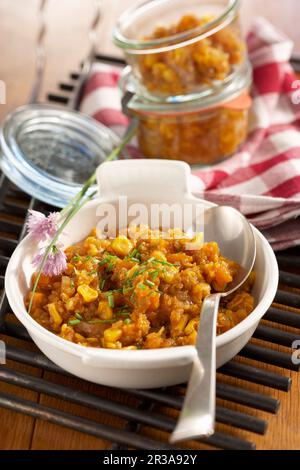 Spicy pumpkin relish in a dish and in jars Stock Photo