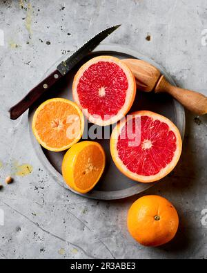 Freshly cut oranges ready to be squeezed Stock Photo