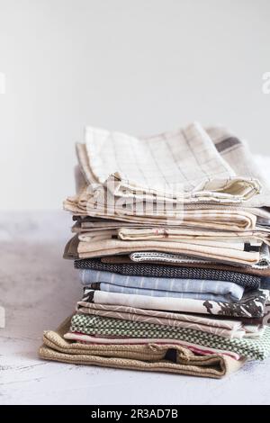Kitchen textile. stack of fabrics in different colors and textures, close-up. Kitchen towels on whit Stock Photo