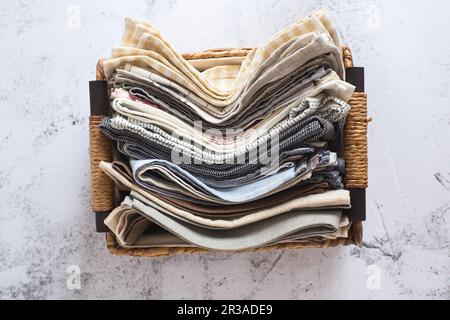 Kitchen textile. stack of fabrics in different colors and textures, close-up. Kitchen towels on whit Stock Photo