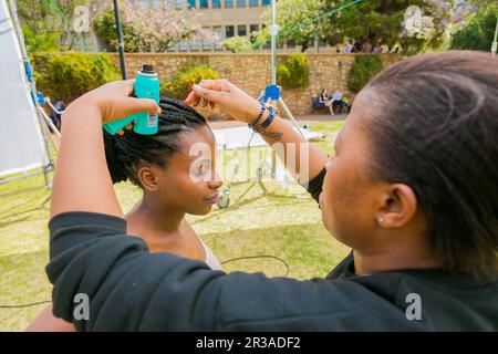 Behind the Scenes Hair and Make-up on location shooting of television commercial advert Stock Photo