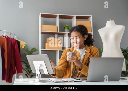 woman telephone and laptop design and shipping an online order sending a package using the internet from her office. technology and logistics with a Stock Photo