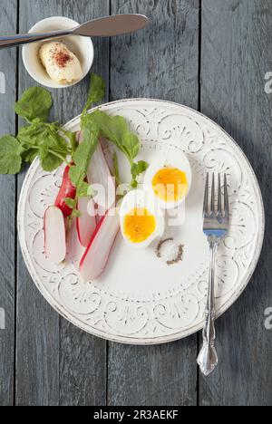 Soft boiled egg with radish salt and pepper, with butter Stock Photo