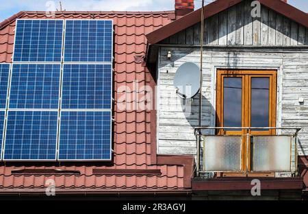 Solar panels on old wooden house Stock Photo