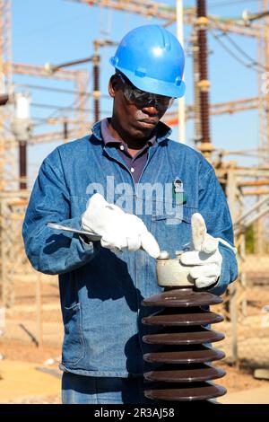 Electricians working on high voltage power lines Stock Photo