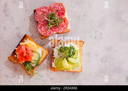 Close-up three sandwiches with various contains on light murble surface Stock Photo