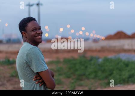 Handsome black man with folded arms and cheerful and happy expression Stock Photo