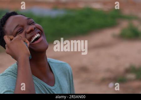 overjoyed African man making call with his mobile phone Stock Photo