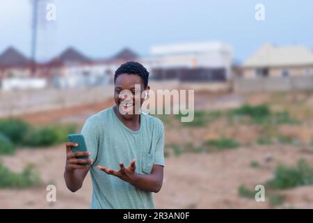 Happy black man using his phone and listening to music Stock Photo