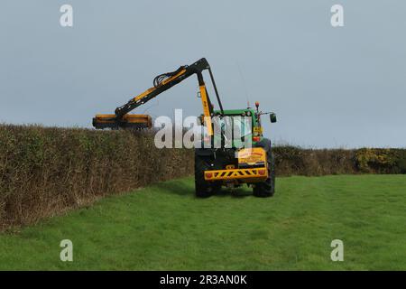 John Deere 6930 Premium with McConnel PA7775T hedge cutter working in a Northern Irish field Stock Photo