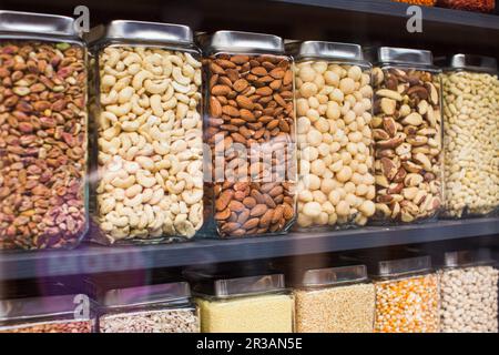 Different types of nuts are packaged in jars for sale Stock Photo