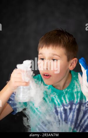 New scientific discoveries. Smart boy scientist screaming in surprise while doing chemical experiments in the laboratory. Education concept. Opening. Stock Photo