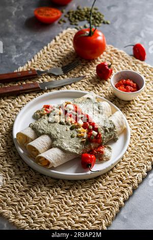 Papadzules - Mexican Yucatan Peninsula - corn tortillas dipped in a sauce of pumpkin seeds filled with boiled eggs Stock Photo