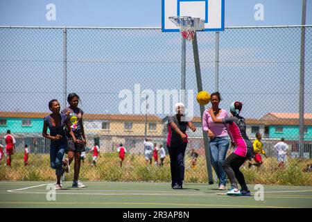 Diverse children playing Netball at school Stock Photo