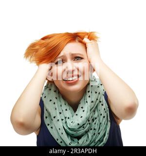 Close-up portrait of a funny red-haired girl emotionally gesticulating and waving his hands isolated Stock Photo