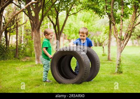 The little boys are interested in the details of a daddy's car Stock Photo