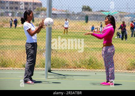 Diverse children playing Netball at school Stock Photo