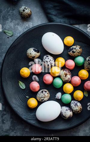 Easter eggs with chocolate candies Stock Photo