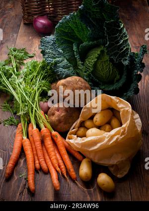 Different types of vegetables (carrots, potatoes, savoy cabbage, onions) Stock Photo