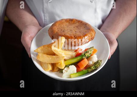 Pie with vegetables and potato wedges Stock Photo