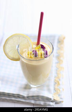 Yogurt smoothie with lemon and violets Stock Photo