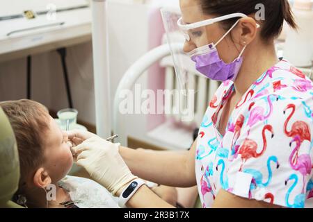 A little boy at a dentist's reception in a dental clinic. Children's dentistry, Pediatric Dentistry. Stock Photo