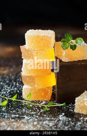 Fruit jelly candies. Homemade orange, pear or apricot candies in sugar on dark background. Fruit che Stock Photo