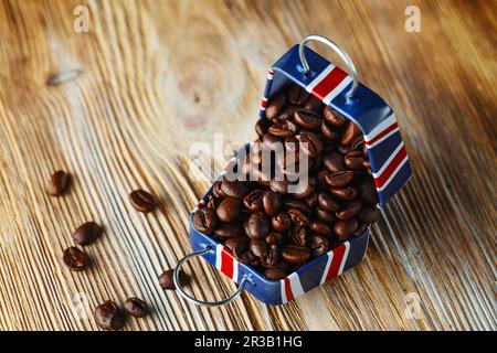 Coffee beans in the small case with britain flag pattern on wooden background Stock Photo