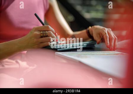 Hand of woman with digitized pen drawing on graphics tablet Stock Photo