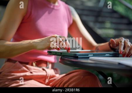 Woman using graphics tablet at table Stock Photo
