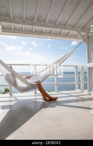Young woman relaxing in hammock Stock Photo