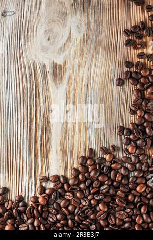 Black coffee beans studio shot. Freshly roasted coffee beans on the wooden texture background Stock Photo