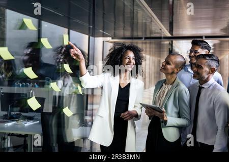 Group of business people doing presentation using post it. Businesswoman leading a team meeting Stock Photo