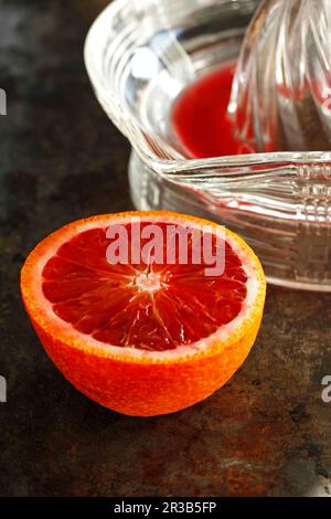 Blood orange and juice on dark background Stock Photo