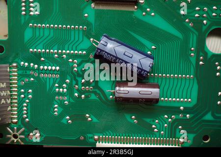 Removed capacitors on electronic circuit board. Stock Photo