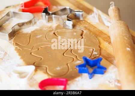 Cooking and decorating christmas gingerbread. Homemade gingerbread cookies, forms and baking ingredi Stock Photo