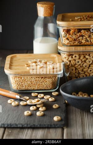 Breakfast cereal. Glass boxes with granola, cereal rings and Quinoa pops. Cereal Loops in a Bowl. He Stock Photo