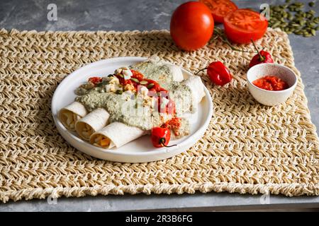 Papadzules (corn tortillas with pumpkin seed sauce, Yucatán) Stock Photo