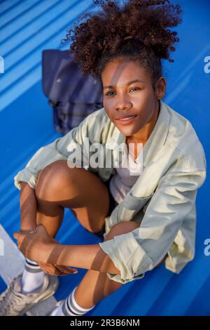 Young woman sitting on floor Stock Photo