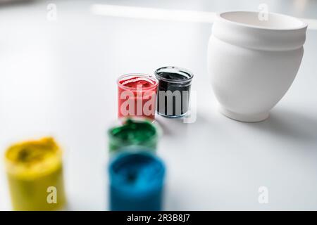 jars of gouache on windowsill - art painting and drawing lessons Stock Photo