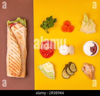 Turkish fastfood doner shawarma roll with meat and vegetables Stock Photo