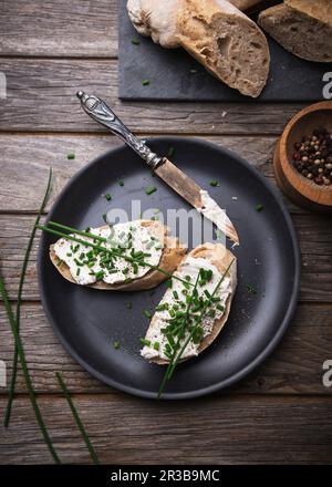 Spelt baguette with almond cream cheese and chives Stock Photo