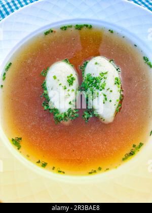 Semolina dumpling soup with chives Stock Photo