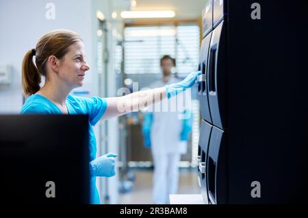 Smiling scientist working in microbiological laboratory Stock Photo