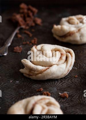 Dough shaped into cinnamon buns, ready to bake Stock Photo