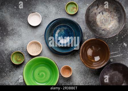 Assorted ceramic hand-made multicolored empty plates and bowls Stock Photo