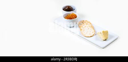Cheese and Crackers on a white plate on a white background isolated Stock Photo