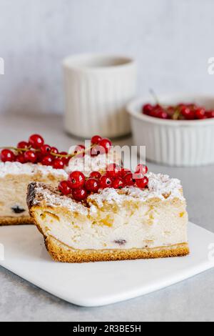 Baked vanilla cheesecake with crust and red currant Stock Photo