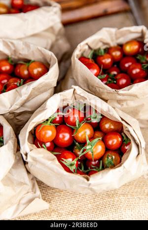 Cherry tomatoes in paper bags Stock Photo
